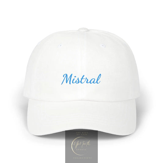 A white baseball cap with the name 'Mistral' embroidered in light blue script across the front, shown on a clean white background with a small gray brand tag above.