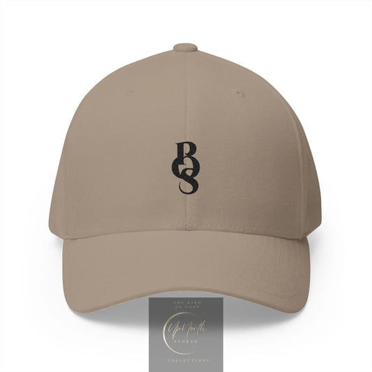 A beige baseball cap with a navy blue embroidered monogram logo on the front - Paparazzi Original