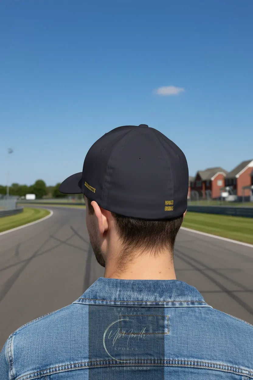 Male model wearing a Dark Navy POS Gold Logo Closed Back Cap shown from left side - Paparazzi Original