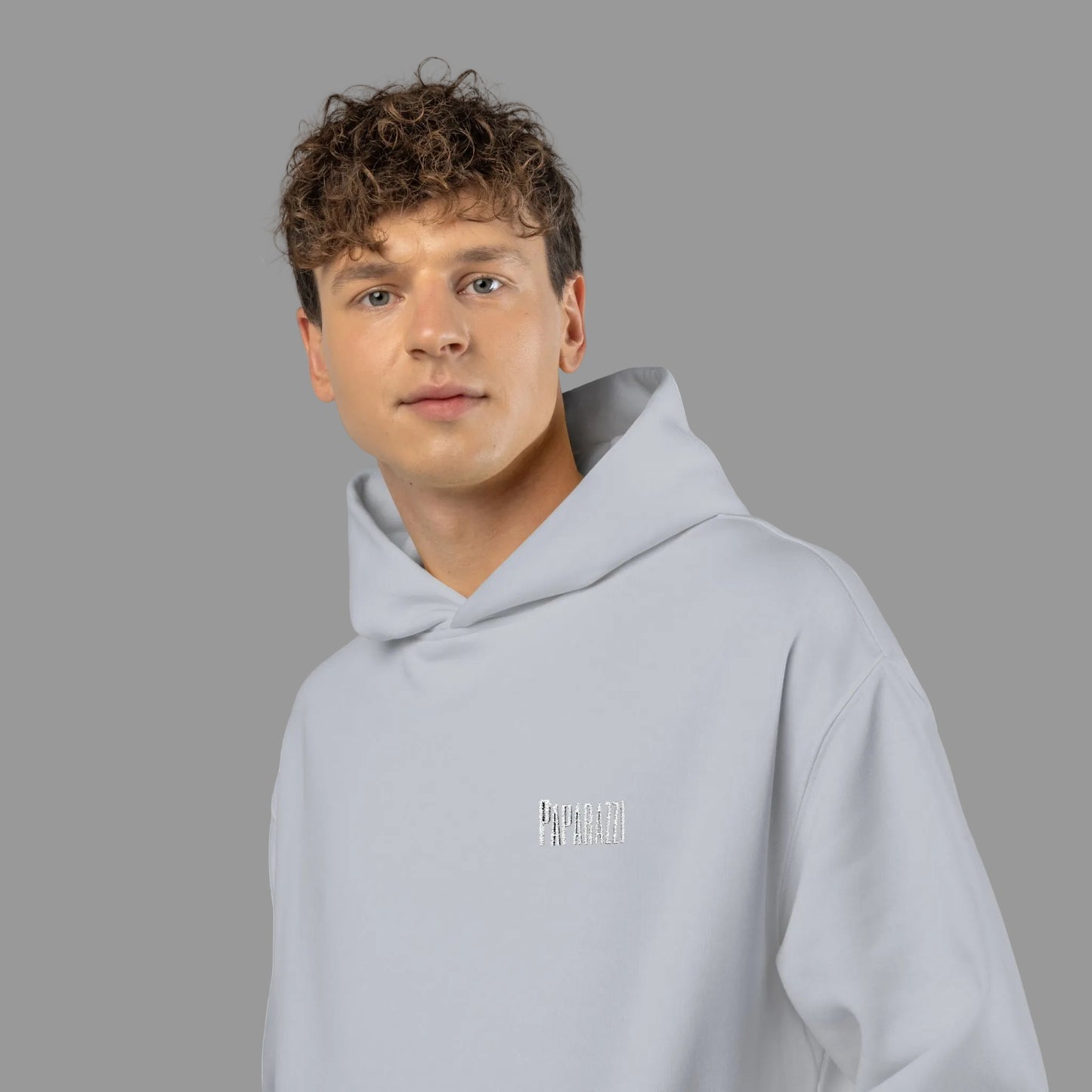 Guy wearing a White Paparazzi Avantgarde Powder White Hoodie Printify