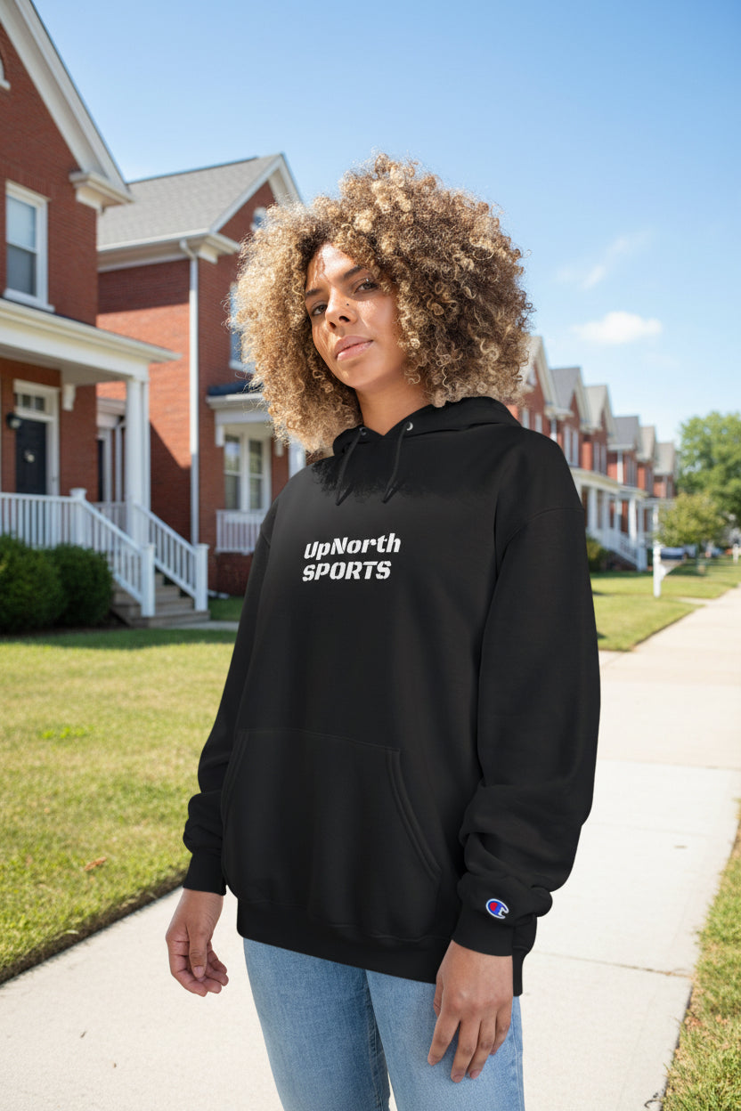 Woman wearing a black hoodie with 'UpNorth Sports' logo, standing outside.